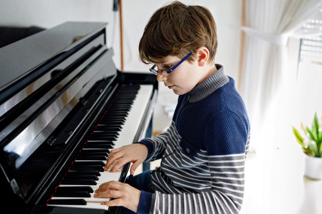 Criança estudando piano