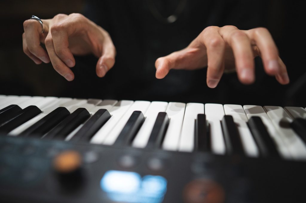 Músico fazendo staccato de braço no piano