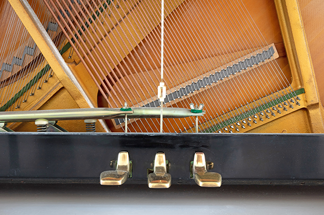 Old piano pedal with close-up shot, old pedal with scratches and dust